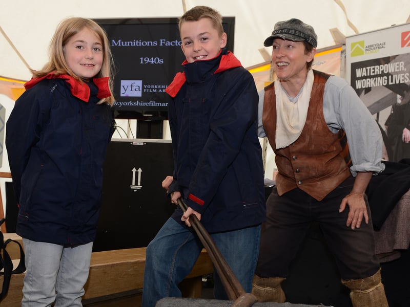 Daniel Ronksley holds a crucible as George the teemer and his sister Vanessa look on in the history tent as BBC's The One Show Road Show visits Endcliffe Park, Sheffield, in August 2012