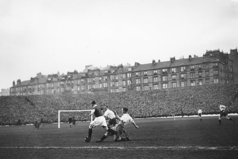 Morgan of Scotland beats two English defenders during the Home Championship match at Hampden Park.  The game finished in a 2-2 draw with goals from Cunningham and Wilson for Scotland. 