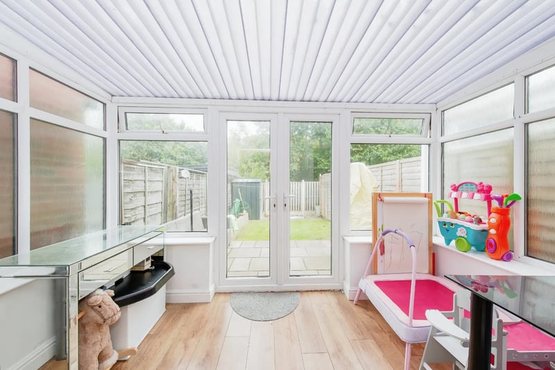 The charming conservatory with access to the rear garden.