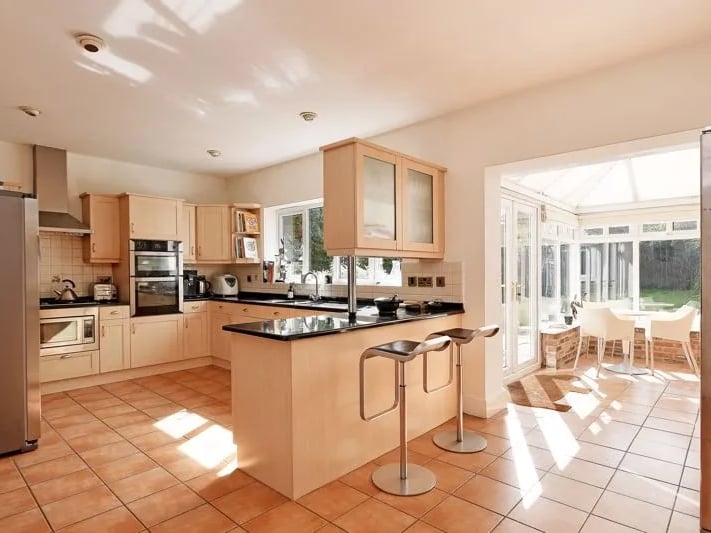 The kitchen flows seamlessly into the conservatory and family room. (Photo courtesy of Zoopla)