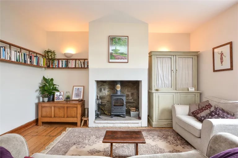 The charming multi-fuel stove set within an exposed stone fireplace adds extra character.