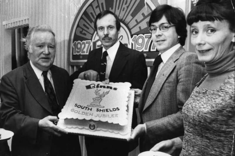 K Price, general manager of Binns, South Shields, cuts the cake to celebrate the firm's 50th anniversary in the town in 1977. Pictured left to right re: E Dennison, G Witten, assistant general manager; and Mrs R Cooper, boutique buyer. Photo: Shields Gazette