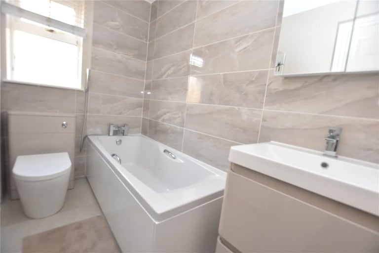 The family bathroom is fitted with a three-piece suite comprising a bathtub, WC and hand wash basin.