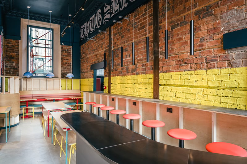 The bright and airy interiors are filled with bent-plywood furniture inspired by a half pipe skate ramp. There’s also a DJ booth and standing tables inspired by New York slice bars, while the exterior is covered in eye-catching graffiti by local artist, Pizza Boy.