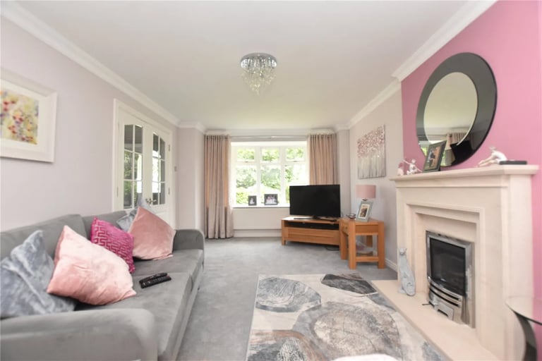 The spacious living room with bay window to the front.