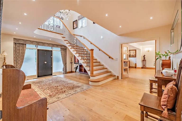 A grand reception hallway with stairs to the first floor greets you upon entry.