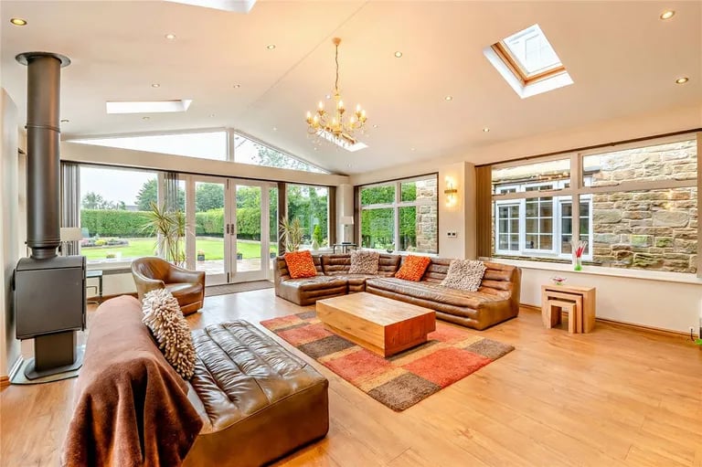 A stunning conservatory with access to the rear gardens.