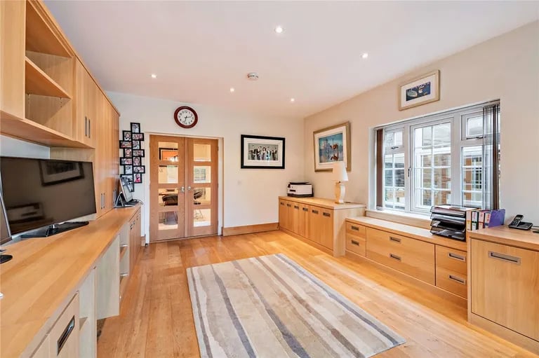 Behind the kitchen is a fitted home office.