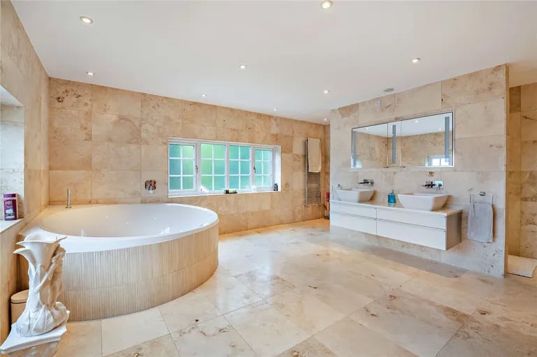 And a stunning ensuite with a jacuzzi-style bathtub.