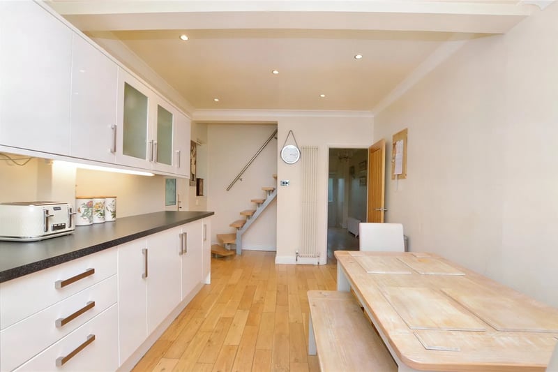 It has integrated appliances and contrasting worktops.