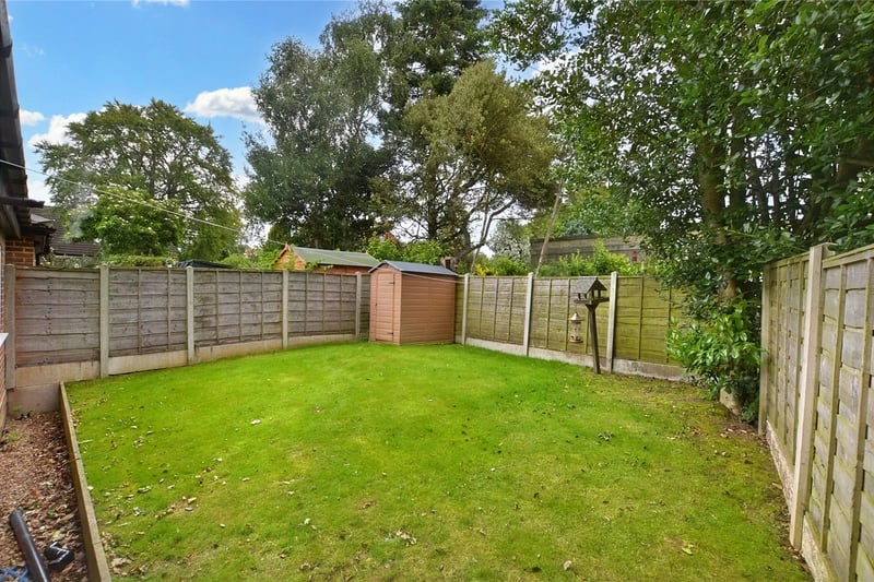 To the rear is a fully enclosed garden with lawn and mature trees. 