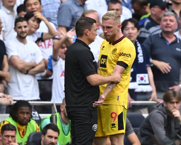 Oli McBurnie explains to Sheffield United boss Paul Heckingbottom why he was sent off against Tottenham (Photo by JUSTIN TALLIS / AFP) 