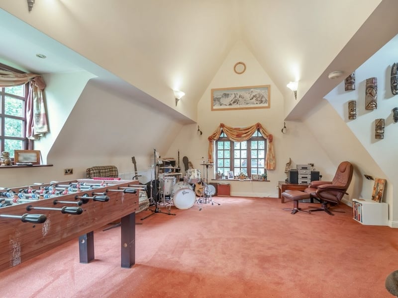 Located at the top of the spiral steps, this games room offers a large space to keep yourself entertained. (Photo courtesy of Fine & Country)