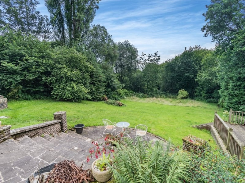 The hillside position of this property means the private, tree-lined garden descends as it goes. (Photo courtesy of Fine & Country)