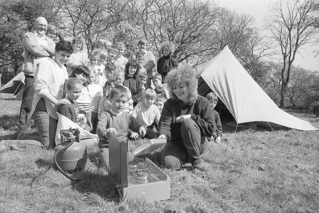 Student teacher Denise Kilner and John Hutchinson get started on the evening meal watched by Valley Road pupils on a camping trip in 1988.