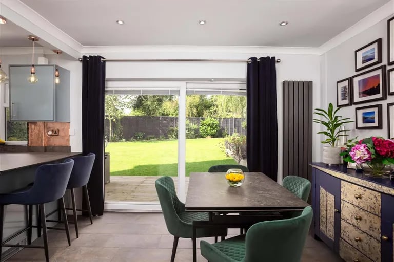 Sliding doors from the dining area leads to the rear garden.