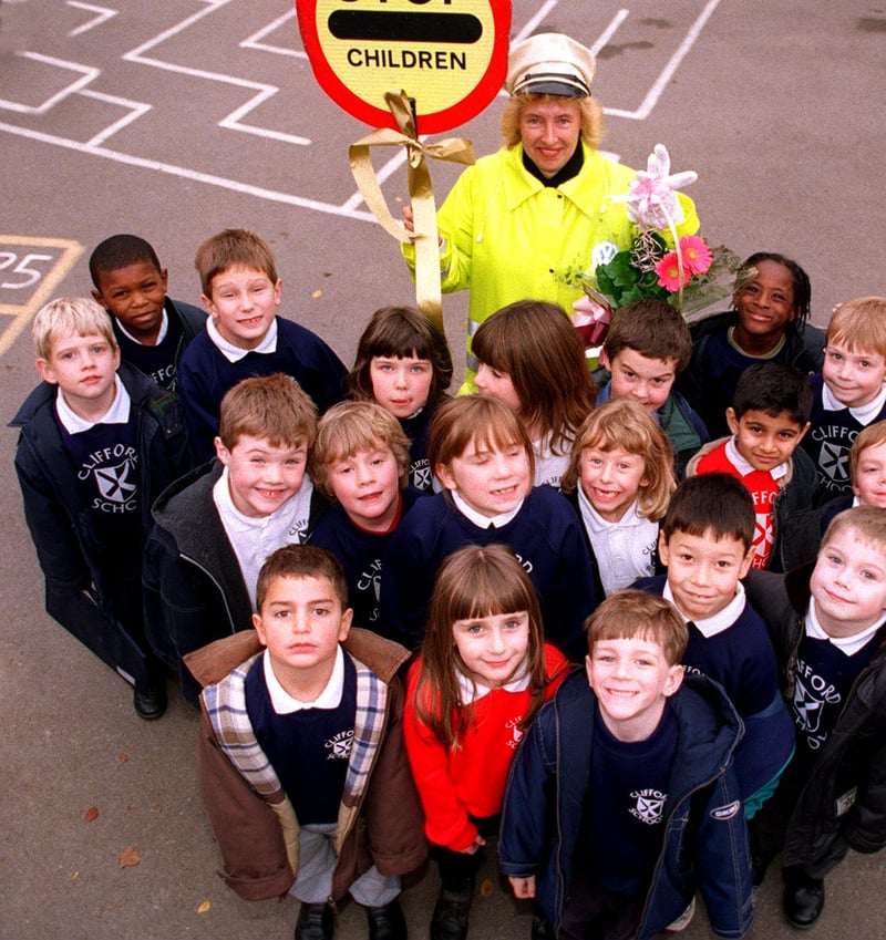 Clifford Infant School lollipop lady Val Nethergate pictured with pupils after serving for 20 years