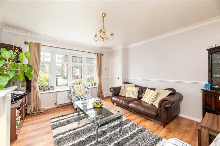 The spacious living room with a feature bay window to the front.