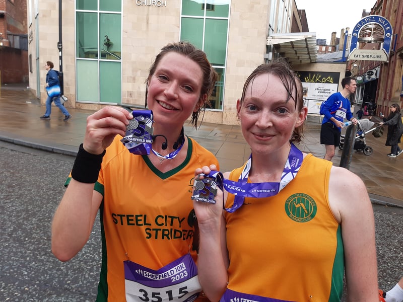 Two runners from  the Steel City Striders club show their medals after completing the Sheffield 10k. Picture: David Kessen, National World