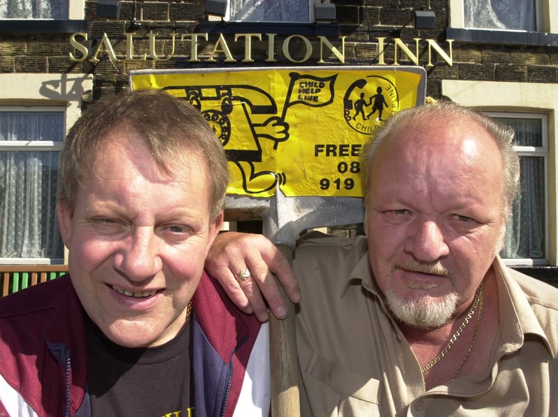 Fundraiser Brian Fletcher, left, who raised more than £70,000 for charity by carrying a hod of brick for hundreds of miles across the country, is pictured with Butch Watkins, landlord of the Salutation Inn pub, in High Green