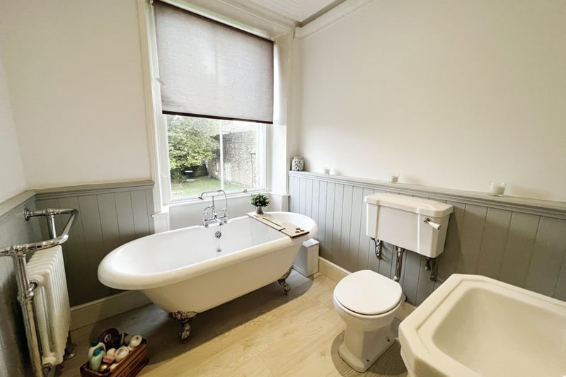 The family bathroom is fitted with a three piece suite; roll top bath, WC wash hand basin, wood panelling and a window to the front elevation.