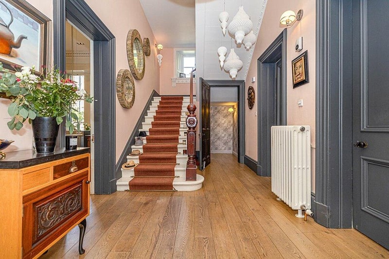 Fabulous, stylish reception hall with wooden flooring, ornate cornicing and original stairway/banister at the rear.
