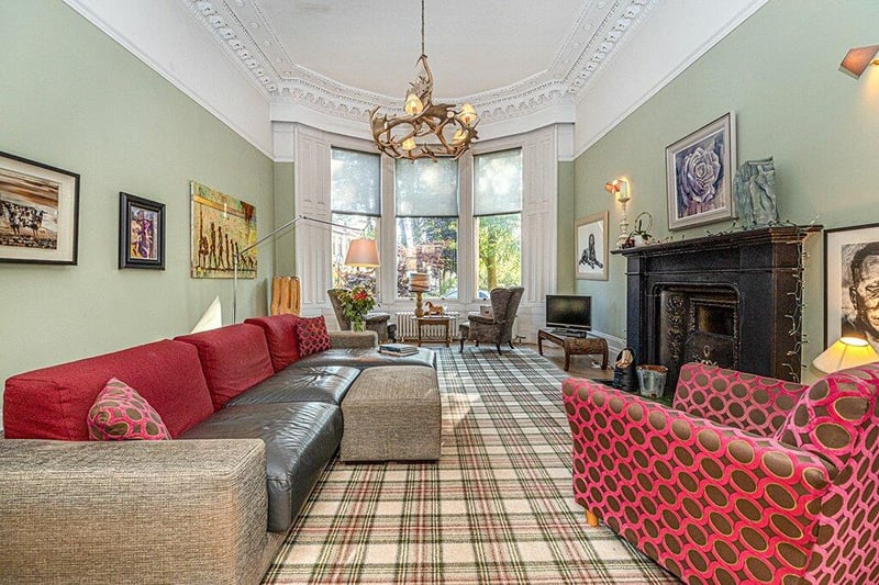 Substantial and elegant drawing room with three section bay window to the front, focal point fireplace, original parquet flooring and beautiful ornate cornicing.
