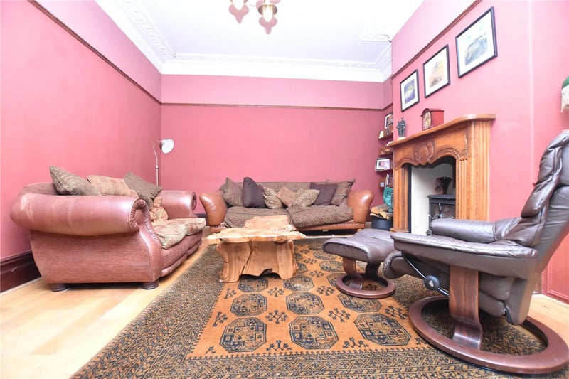 It also features decorative picture rail and log-burning stove inset to a hearth and surround.