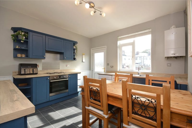 The open plan kitchen and dining area is fitted with shaker style wall and base units.