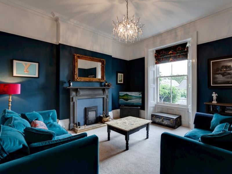 The focal point of this ground floor sitting room is said to be the AGA log burner, with a "timber mantel, a stone surround/heath and a brass fender". (Photo courtesy of Blenheim Park Estates)