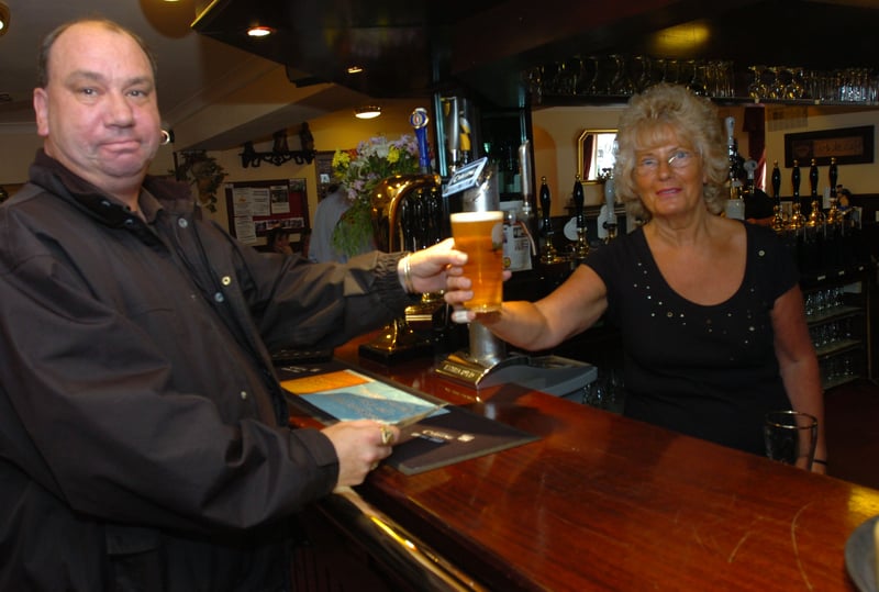 Landlady Wendy Woodhouse serves Ronny Biggin with his first pint in the re-opened Harlequin pub on Nursery Street, Sheffield, in 2007