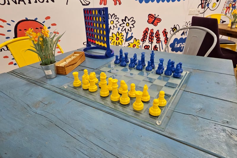 Visitors can borrow and play the board games available in the community hub.
