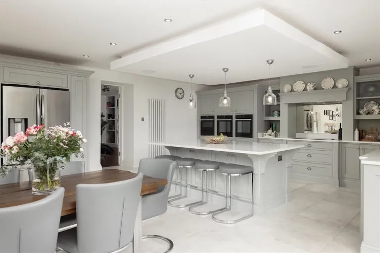 The modern kitchen with integral appliances and a large breakfast island.