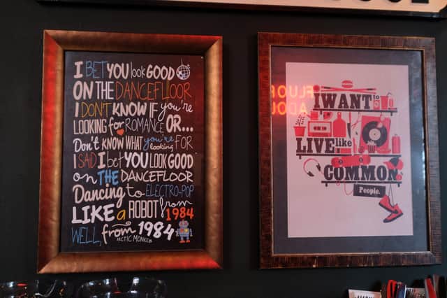 Framed posters on the walls of the Frog & Parrot pub on Division Street in Sheffield city centre celebrate some of the most famous lyrics to have come out of the city, by the Arctic Monkeys and Pulp
