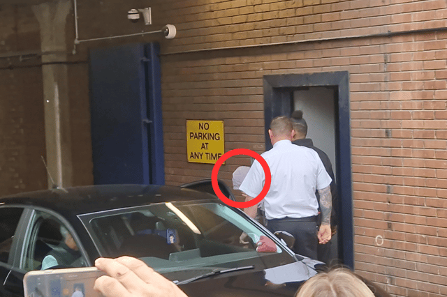 Dale Houghton dove head first into a waiting black Peugeot as he attempted to avoid reporters outside Sheffield Magistrates Court. (Photo courtesy of Harry Harrison)