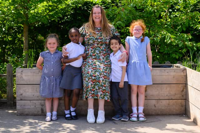 Ann Farrar, Headteacher of Anns Grove Primary School, with pupils. Photo credit: Colin Perkins Photography