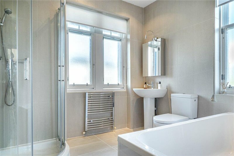 Main family bathroom (Laufen Pro) with four piece white suite including separate shower cubicle. Two windows to the front and window to the side. 