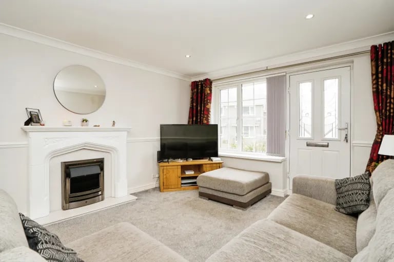 As you enter you're greeted by this bright and spacious living room.