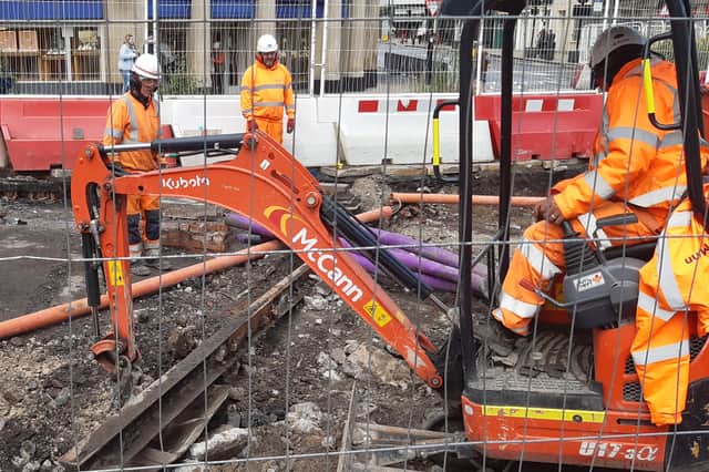 Workmen digging out a section of tram track at the top of Fargate, Sheffield. Picture: David  Kessen, National World