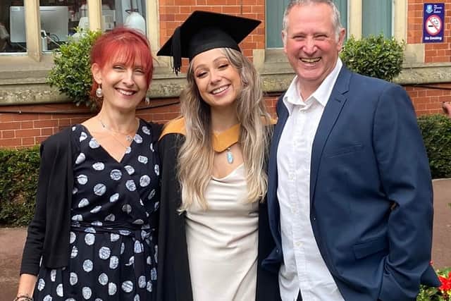 Morgan and her parents at her undergraduate graduation in 2021
