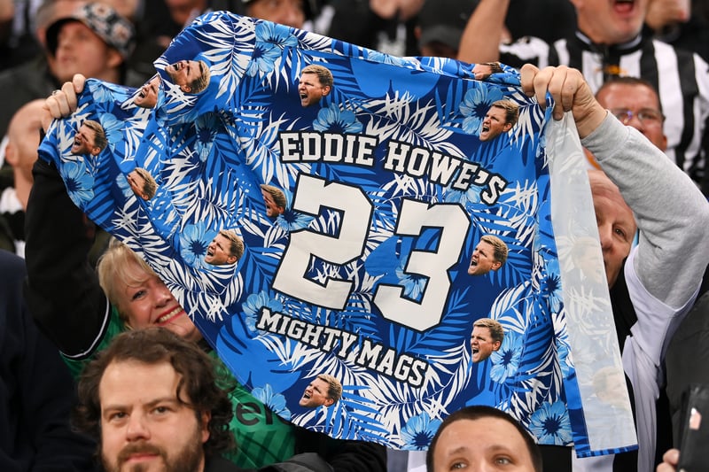 Fans of Newcastle United hold a customised t-shirt that reads 'Eddie Howe's Mighty Mags - 23' during the UEFA Champions League match between Newcastle United FC and Paris Saint-Germain at St. James Park on October 04, 2023 in Newcastle upon Tyne, England. (Photo by Stu Forster/Getty Images)