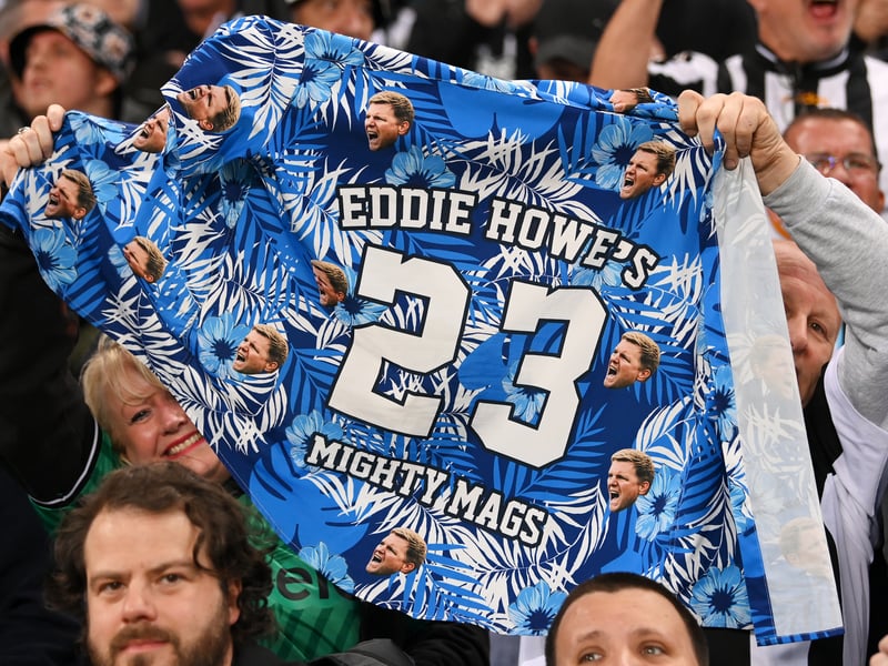 Fans of Newcastle United hold a customised t-shirt that reads 'Eddie Howe's Mighty Mags - 23' during the UEFA Champions League match between Newcastle United FC and Paris Saint-Germain at St. James Park on October 04, 2023 in Newcastle upon Tyne, England. (Photo by Stu Forster/Getty Images)