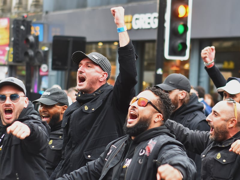 An iconic scene of PSG fans passionately marching past Greggs (Credit: Andrew White)