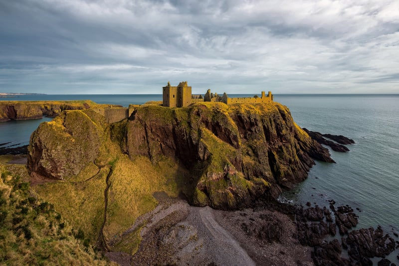 You can find Dunnottar Castle along the Aberdeenshire Coastal Trail on a rocky outcrop, around twenty miles from Aberdeen itself. Some believe that the site was originally inhabited by the Picts who may have done so as far back as 5000 BC. The name “Dunnottar” is derived from the Gaelic “Dùn Fhoithear” which means “fort on the shelving slope”.