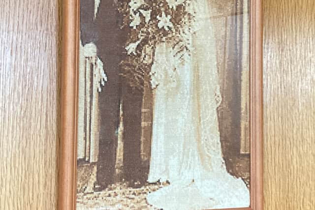 This is not a photo - it's an embroidered piece of artwork by Joan, of her and Granville's wedding photo, which hangs in the front room.