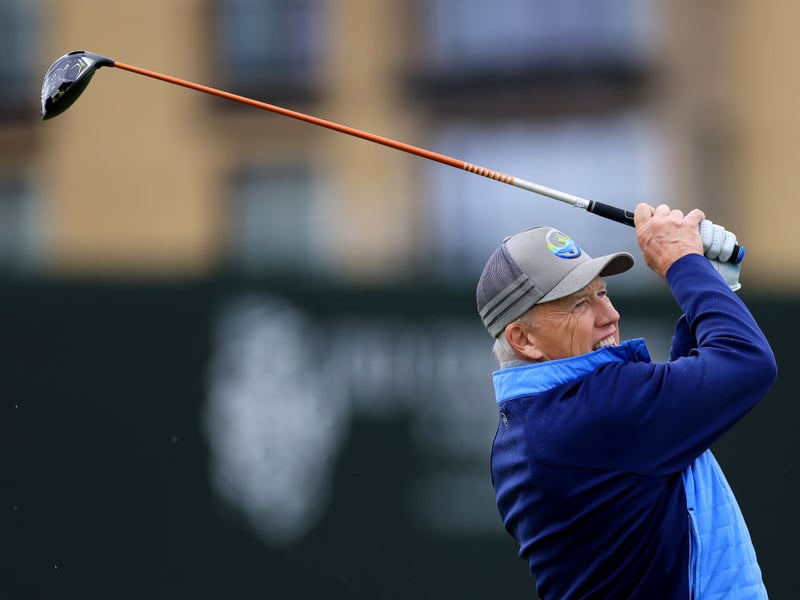 Former American Footballer John Elway tees off on the third hole at the Old Course, St Andrews.