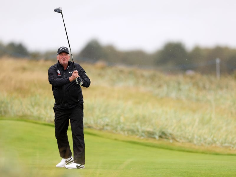 Former Cricketer and Member of the House of Lords Ian Botham tees off on the fifth hole at Carnoustie Golf Links.
