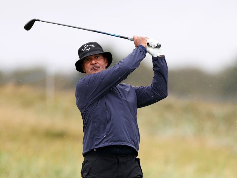 Former footballer and manager Ruud Gullit tees off on the fifth hole at Carnoustie Golf Links.