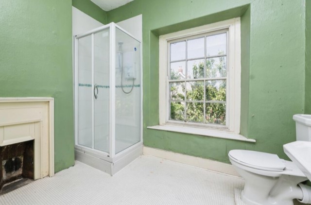 The bathroom has original sash windows.