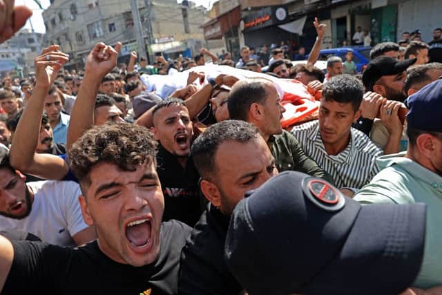 Palestinians carry the body of a victim that was killed in an Israeli strike, in Khan Yunis in the southern Gaza Strip on October 7, 2023. Credit: AFP via Getty Images